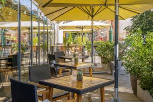 a group of tables with umbrellas on a patio at INNSiDE by Meliá Berlin Mitte in Berlin