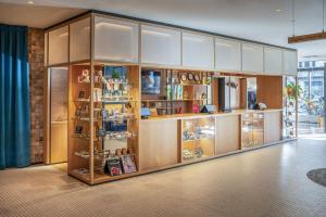 a store with wooden cabinets and shelves with products at INNSiDE by Meliá Berlin Mitte in Berlin +43 photos