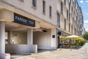 a building with a sign for a restaurant at INNSiDE by Meliá Berlin Mitte in Berlin
