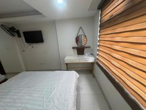 a bedroom with a bed and a wooden wall at Hanoi Gold Hotel Near Bach Mai in Hanoi