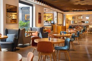 a restaurant with tables and chairs in a room at INNSiDE by Meliá Prague Old Town in Prague