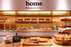 a bakery with bread and pastries on a counter at INNSiDE by Meliá Prague Old Town in Prague +77 photos
