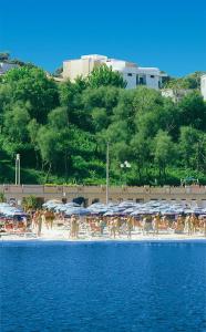 a group of people on a beach with umbrellas at Residence Bellevue in Gabicce Mare