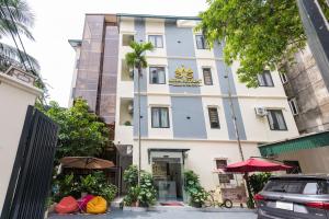 a white building with a sign on it at Aura Retreat Boutique Hotel Hanoi in Hanoi