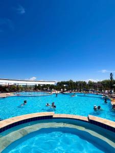 a pool at a resort with people swimming in it at Diona Raduga West in Koshkolʼ +26 photos