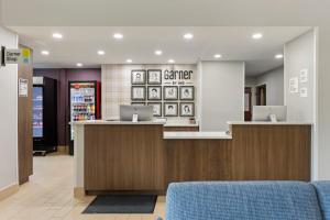 a lobby of a store with two laptops on the counter at Garner Hotel Warren Northwest by IHG in Warren