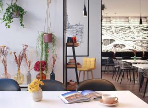 a table with a book and a cup of coffee on it at Hotel Paris Opéra, Affiliated by Meliá in Paris