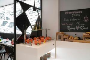 a table with bottles of wine and a chalkboard at Hotel Paris Opéra, Affiliated by Meliá in Paris