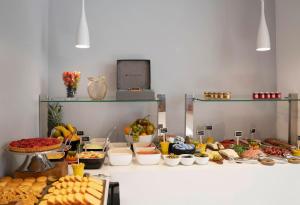 a buffet with many different types of food on display at Hotel Paris Opéra, Affiliated by Meliá in Paris +38 photos