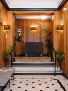 a waiting room with a couch in a lobby at Meliá Paris Champs Elysées in Paris