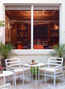 a patio with a table and chairs and a tv at Meliá Paris Champs Elysées in Paris +28 photos