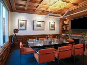 a dining room with a table and chairs at Meliá Paris Champs Elysées in Paris