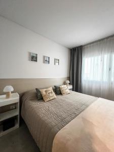 a bedroom with a large bed and a window at Caleta VIEW - Alojamientos in Puerto Madryn +18 photos