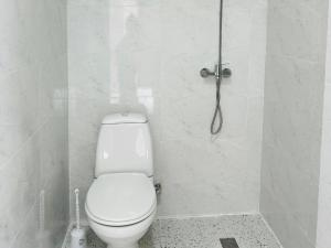 a white bathroom with a toilet and a shower at SOPHIA Hotel Ureki in Ureki +19 photos