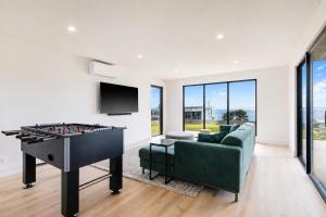 a living room with a pool table and a couch at The Bay View San Remo by Ready Set Stay- BYO LINEN & TOWELS in San Remo +16 photos