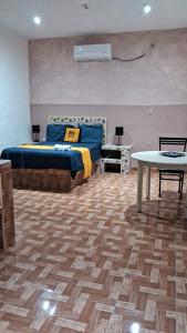 a bedroom with a bed and a table in it at Mi Hotel Club in Lázaro Cárdenas +16 photos