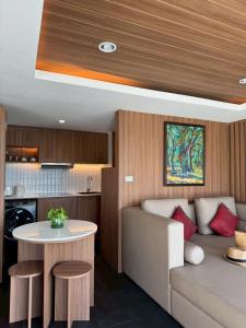 a kitchen and living room with a couch and a table at The Front Hotel and Apartments in Patong Beach