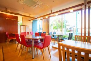 a restaurant with tables and chairs and a large window at En Hotel Akita エンホテル秋田 in Akita