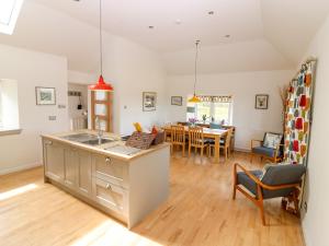 a kitchen and living room with a dining room at Whitehouse Woodwrae in Forfar