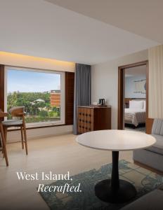 a living room with a table and a bed at Le Meridien Kochi in Cochin +106 photos