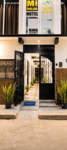 a hotel entrance with a black door and potted plants at Mi Hotel Club in Lázaro Cárdenas