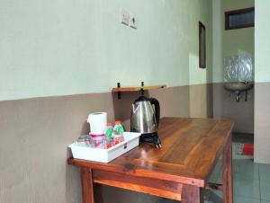 a wooden table with a tea kettle on top of it at Tengger Indah Seruni Bromo in Probolinggo