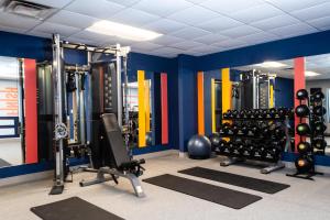 a gym with lots of equipment in a room at Hampton Inn & Suites Addison in Addison