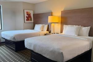 a hotel room with two beds and two lamps at Sleep Inn & Suites Peoria North in Peoria +8 photos
