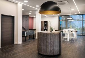 a lobby with a round table and a black ceiling at elaya hotel augsburg, Trademark by Wyndham in Augsburg