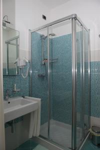 a bathroom with a glass shower and a sink at Hotel Perla Dello Ionio in Torre Lapillo
