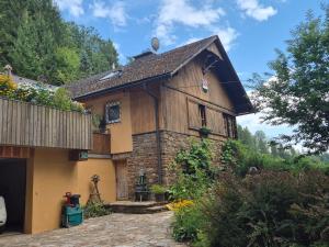 a small house with a stone and wood at Appartment Haus Zirknitz in Mitterzirknitz