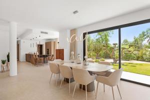 a dining room and kitchen with a table and chairs at Villa Augusta in Tourrettes