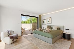 a bedroom with a large bed and a chair at Villa Augusta in Tourrettes +31 photos