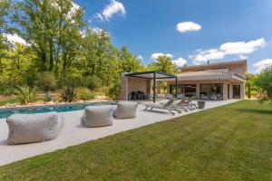 a backyard with a swimming pool and a house at Villa Augusta in Tourrettes