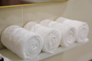 a bunch of rolled towels on a shelf at Sunrise Hotel Phước Kim in Bạc Liêu +57 photos