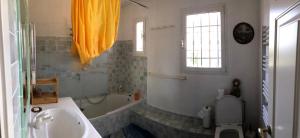 a bathroom with a tub and a toilet and a sink at Domaine Sagittaires in Le Cannet-des-Maures