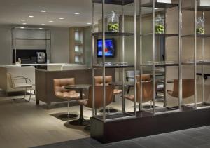 a lobby with a bar with chairs and a counter at Hyatt Grand Central New York in New York