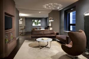 a living room with a couch and a table at Hyatt Grand Central New York in New York