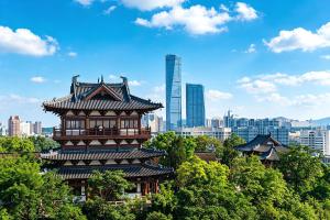 a chinese building with a city in the background at Zhenjiang Marriott Hotel in Zhenjiang