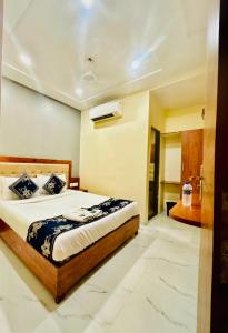 a bedroom with a bed and a bath room at Hotel Purple Orchid in Mumbai +64 photos