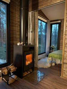 a living room with a fireplace in a log cabin at Borealis Village XXL |Sauna|WiFi|Ylläs|Aurora in Äkäslompolo