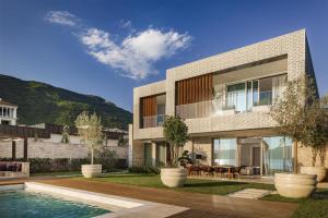 an exterior view of a house with a swimming pool at One&Only Portonovi in Herceg-Novi