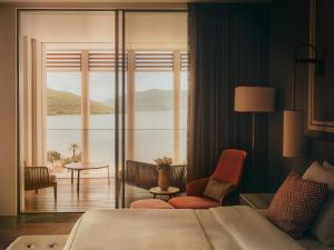 a hotel room with a bed and a view of the water at One&Only Portonovi in Herceg-Novi +193 photos