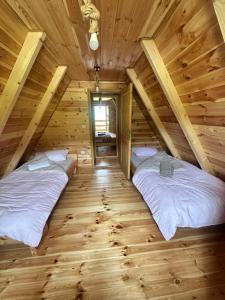 two beds in the attic of a log cabin at Vila Gorska in Šavnik +18 photos