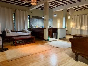a large living room with a tub and a kitchen at Tropinest bungalows & hostel in Nungwi