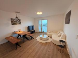 a living room with a couch and a table at Maritime Suite an der Geeste in Bremerhaven