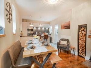 a kitchen and living room with a table and chairs at Beaconsfield House in Mundesley +26 photos