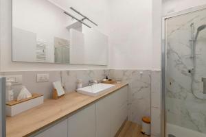 a white bathroom with a sink and a shower at Casa Vacanze Regina in Lecco +17 photos