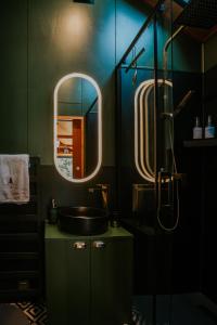 a bathroom with a sink and a mirror at Feelmore Tiny House Karancsalja in Karancsalja +3 photos