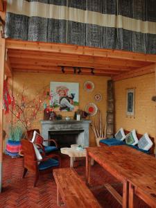 a living room with a table and a fireplace at Ap Retreat - Ta Van's Heel in Sapa